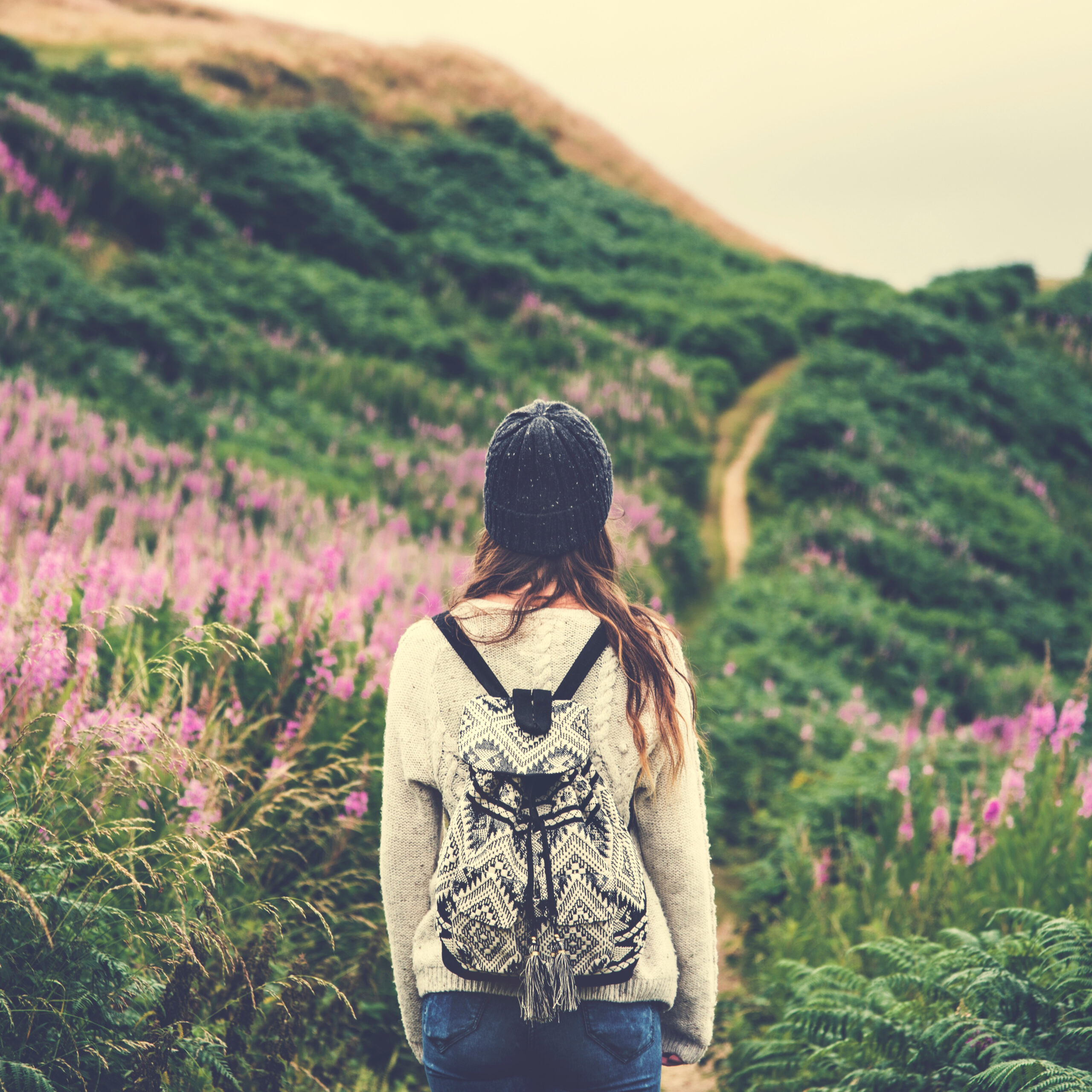 Woman walking on hillside path